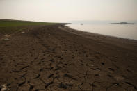 Cracked earth lines the banks of the Villa Victoria Dam, the main water supply for Mexico City residents, on the outskirts of Toluca, Mexico, Thursday, April 22, 2021. The mayor of Mexico City said Mexico's drought was the worst in 30 years. (AP Photo/Fernando Llano)