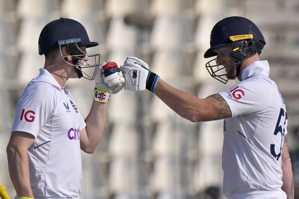 England's Harry Brook, left, celebrates with teammate Ben Stokes after scoring century during the third day of the second test cricket match between Pakistan and England, in Multan, Pakistan, Sunday, Dec. 11, 2022. (AP Photo/Anjum Naveed)