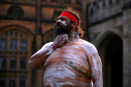 An Australian Aboriginal man wearing traditional dress prepares to perform in a welcoming ceremony at Government House in Sydney, Australia, June 28, 2017. REUTERS/David Gray