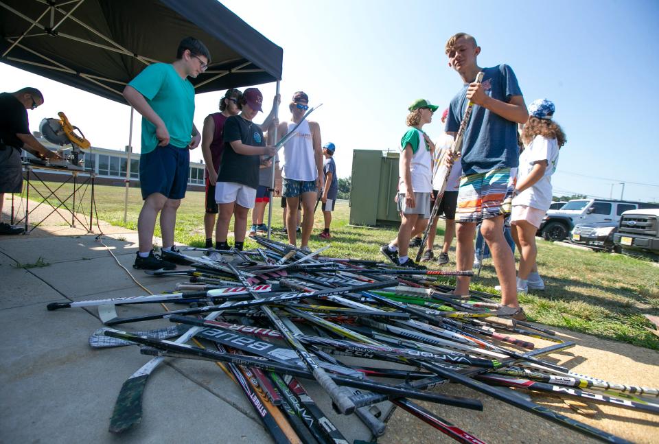 Members of the Central Regional hockey team make oyster reefs from recycled hockey sticks. The environmental group NY/NJ Baykeeper has collected donated hockey sticks and partnered with Central Regional High School to construct oyster reefs.  Bayville, NJWednesday, July 20, 2022