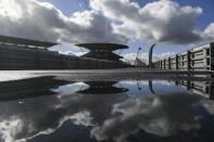 Clouds are reflected in a puddle prior to the start of the third practice session for the Eifel Formula One Grand Prix at the Nuerburgring racetrack in Nuerburg, Germany, Saturday, Oct. 10, 2020. The Germany F1 Grand Prix will be held on Sunday. (Ina Fassbender, Pool via AP)