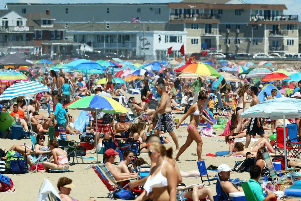 A large crowd enjoys a hot summer day at Hampton Beach.