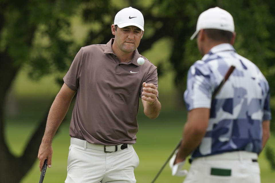 Scottie Scheffler catches a ball before putting on the fourth hole during the first round of the Byron Nelson golf tournament in McKinney, Texas, Thursday, May 11, 2023. (AP Photo/LM Otero)