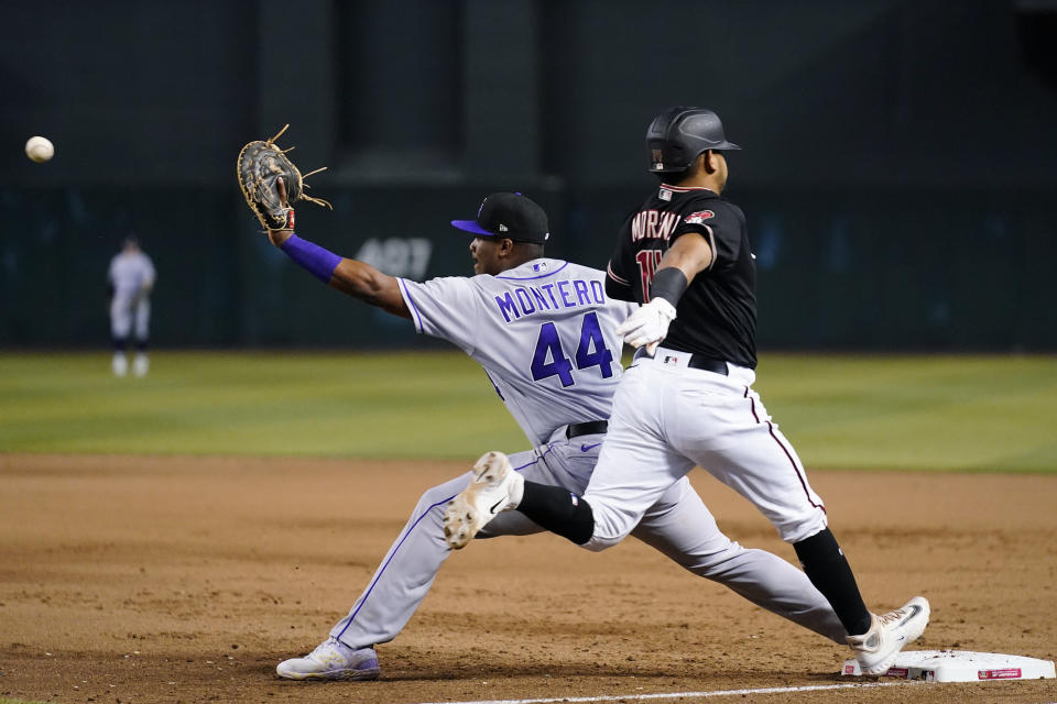 Arizona Diamondbacks' Gabriel Moreno, right, beats out an infield single as Colorado Rockies first baseman Elehuris Montero (44) reaches for the throw during the fifth inning of a baseball game Wednesday, May 31, 2023, in Phoenix. (AP Photo/Ross D. Franklin)