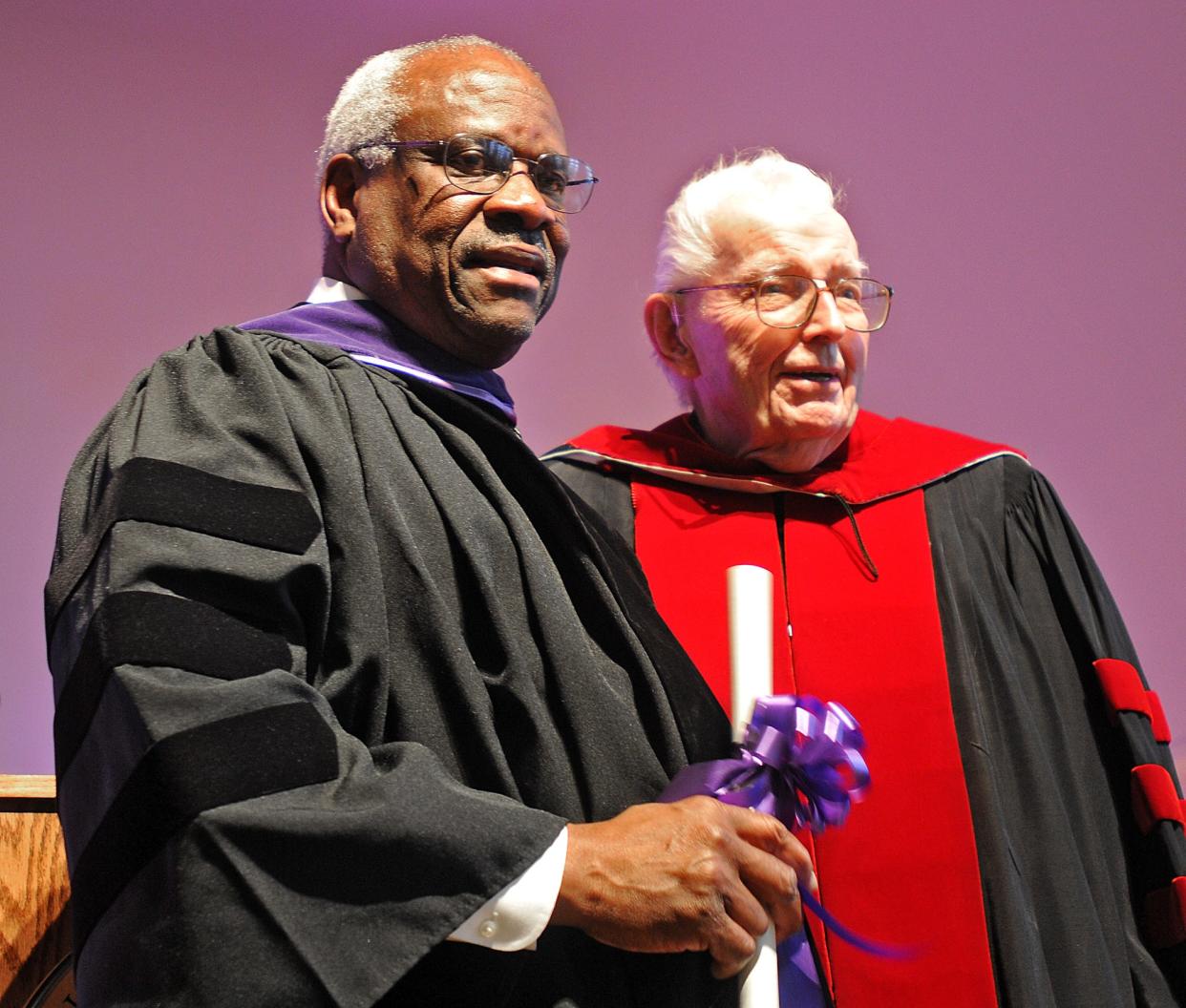 Holy Cross graduate Clarence Thomas stands with Rev. John E. Brooks, a former president of Holy Cross, during a convocation Jan. 26, 2012.