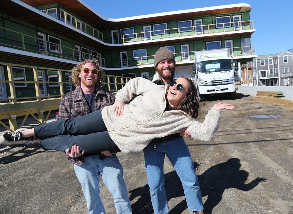 Artists Dan Dellapasqua, left, and Kyle Nelson have some fun with Haven Hatch, the COO at Crane Hotel Group, as they stand in front of the Nevada Motel at York Beach.