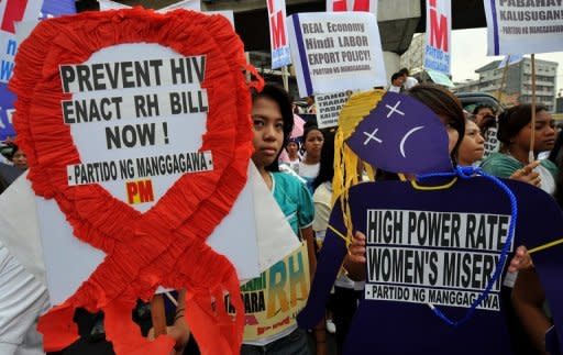 Filipino women activists march in Manila to mark the 100th International Women's Day on March 8, 2011. The Philippines is struggling to deal with a worsening HIV-AIDS problem, with far too little money being spent on reversing a steady rise in infection rates, health experts warn