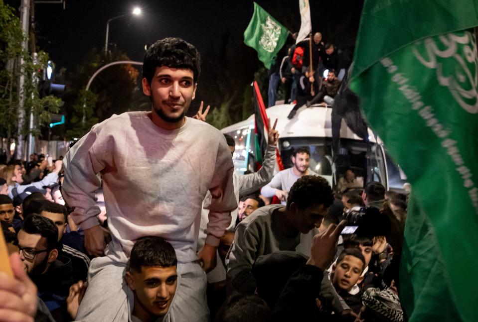 Freed Palestinian prisoners (wearing grey jumpers) cheer among supporters and relatives after being released from Israeli prisons after Hamas released Israeli hostages, in Ramallah, in the occupied West Bank, Nov. 26, 2023. / Credit: FADEL SENNA/AFP/Getty