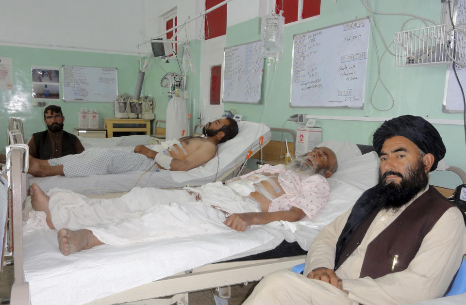 Wounded Afghans lie on a bed at a hospital after fighting between Taliban and Afghan security forces in Kandahar province south of Kabul, Afghanistan, Thursday, Aug. 5, 2021. (AP Photo/Sidiqullah Khan)