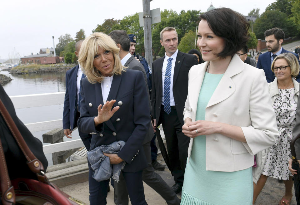 Jenni Haukio, wife of Finland President Sauli Niinisto, right, and Brigitte Macron, wife of French President Emmanuel Macron visit Suomenlinna Fortress in Helsinki, Finland, Thursday Aug. 30, 2018. President Macron is in Finland on a two-day official visit. (Martti Kainulainen/Lehtikuva via AP)