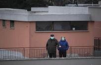 People listen to the music, as DJ Francesco Cellini plays for them from the rooftop terrace, as Italians remain under lockdown to prevent the spread of coronavirus disease (COVID-19) in Monteverde district, Rome