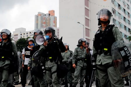 FILE PHOTO: Riot police ask anti-extradition bill protesters to leave in front of public housing after a march at Sha Tin District of East New Territories, Hong Kong