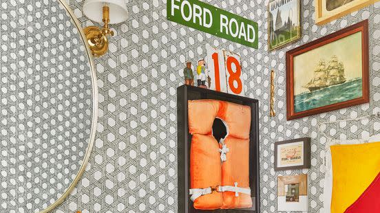 eclectic gallery wall in corner of powder room with pedestal sink, gold fixtures, gray wallpaper with large scale woven pattern, in 1970s dutch colonial style home of victoria ford and marcus fo