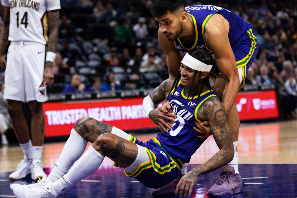 Utah Jazz center Omer Yurtseven (77) helps teammate Utah Jazz guard Jordan Clarkson (00) up from the court during an NBA basketball game between the Utah Jazz and the New Orleans Pelicans at the Delta Center in Salt Lake City on Monday, Nov. 27, 2023. | Megan Nielsen, Deseret News