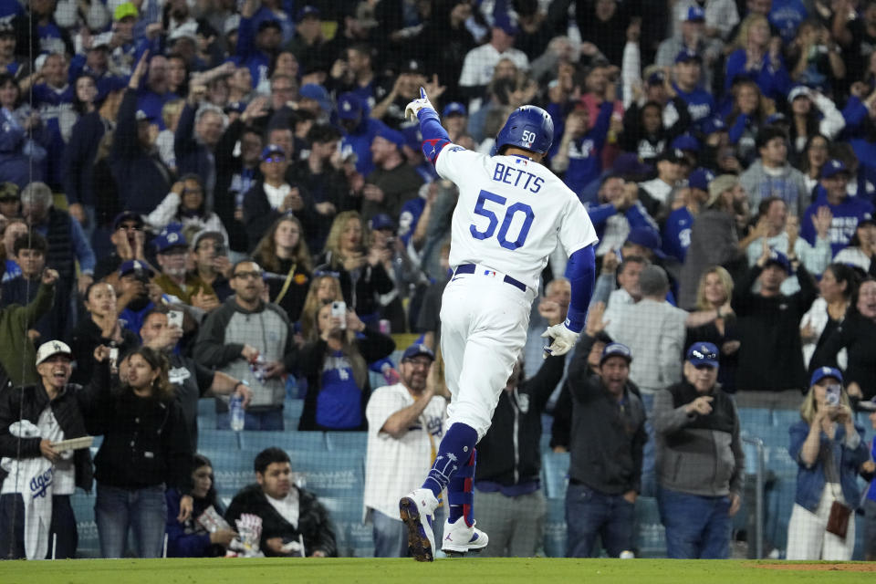 Los Angeles Dodgers' Mookie Betts gestures after hitting a solo home run during the seventh inning of a baseball game against the San Diego Padres Friday, May 12, 2023, in Los Angeles. (AP Photo/Mark J. Terrill)