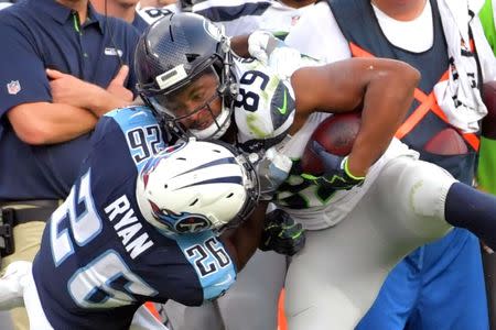 Sep 24, 2017; Nashville, TN, USA; Tennessee Titans cornerback Logan Ryan (26) tackles Seattle Seahawks wide receiver Doug Baldwin (89) during the second half at Nissan Stadium. Mandatory Credit: Jim Brown-USA TODAY Sports