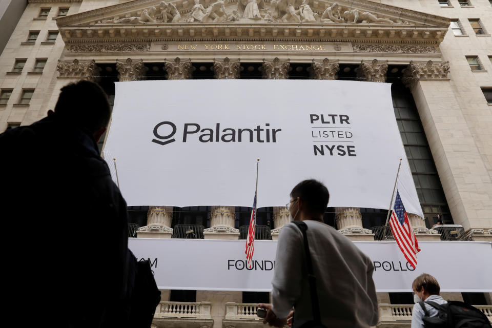 People walk by a banner featuring the logo of Palantir Technologies (PLTR) at the New York Stock Exchange (NYSE) on the day of their initial public offering (IPO) in Manhattan, New York City, U.S., September 30, 2020. REUTERS/Andrew Kelly