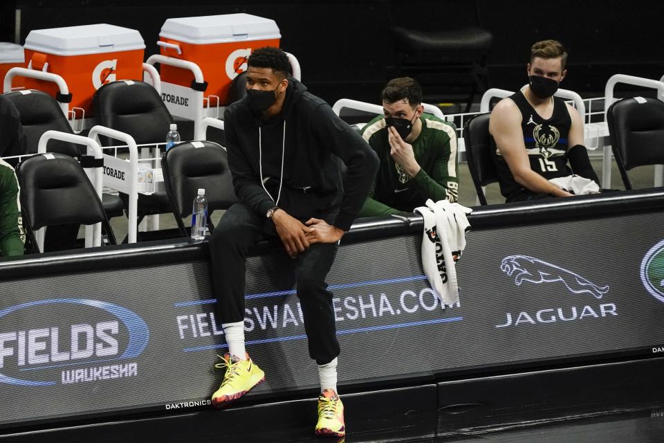 Milwaukee Bucks' Giannis Antetokounmpo watches from the bench during the second half of an NBA basketball game against the Charlotte Hornets Friday, April 9, 2021, in Milwaukee. Antetokounmpo didn't play because of an injury. (AP Photo/Morry Gash)