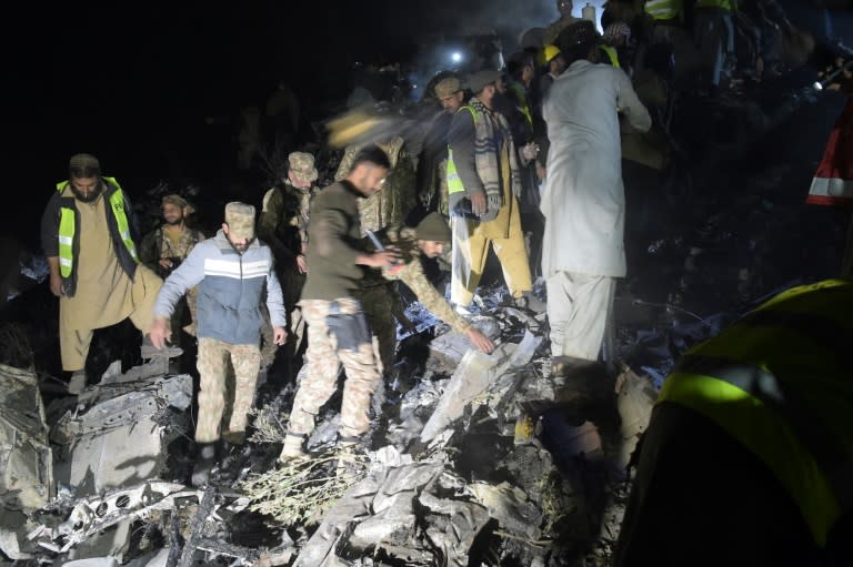 Pakistani soldiers and volunteers search for victims from the wreckage of the crashed PIA passenger plane, flight PK661, near the village of Saddha Batolni, in the Abbottabad district of Khyber Pakhtunkhwa province, on December 7, 2016