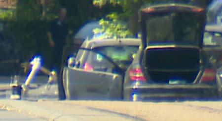 A bomb disposal robot is seen searching a car in the Brussels' commune of Woluwe St Pierre, June 30, 2018. RTL Television. TV Picture taken June 30, 2018. Reuters TV via REUTERS TV.