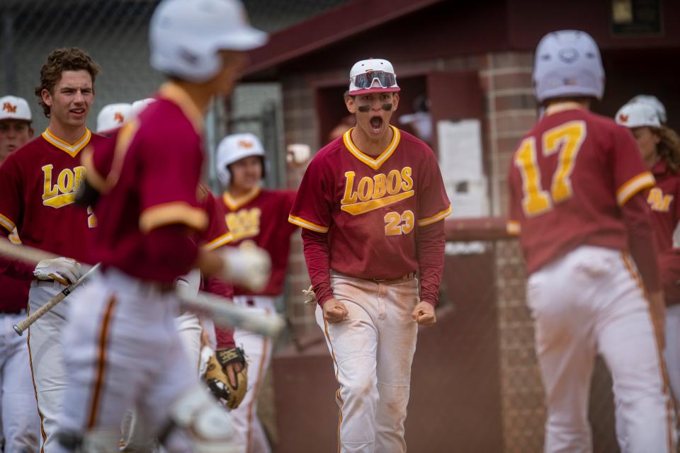 Rocky Mountain's Eric Bergquist (23) and his teammates celebrate after Phoenix West scored a run during a 2022 game. The Lobos are off to a 9-0 start this season.