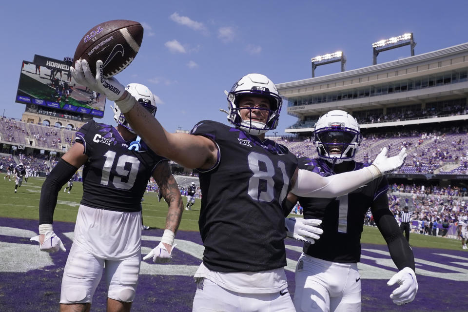 TCU tight end Chase Curtis (81) celebrates his touchdown with teammates Jared Wiley (19) and Cordale Russell (1) during the second half of an NCAA college football game against SMU Saturday, Sept. 23, 2023, in Fort Worth, Texas. (AP Photo/LM Otero)