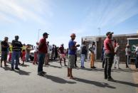 People queueing to withdraw cash from an ATM exercise social distancing, in Cape Town