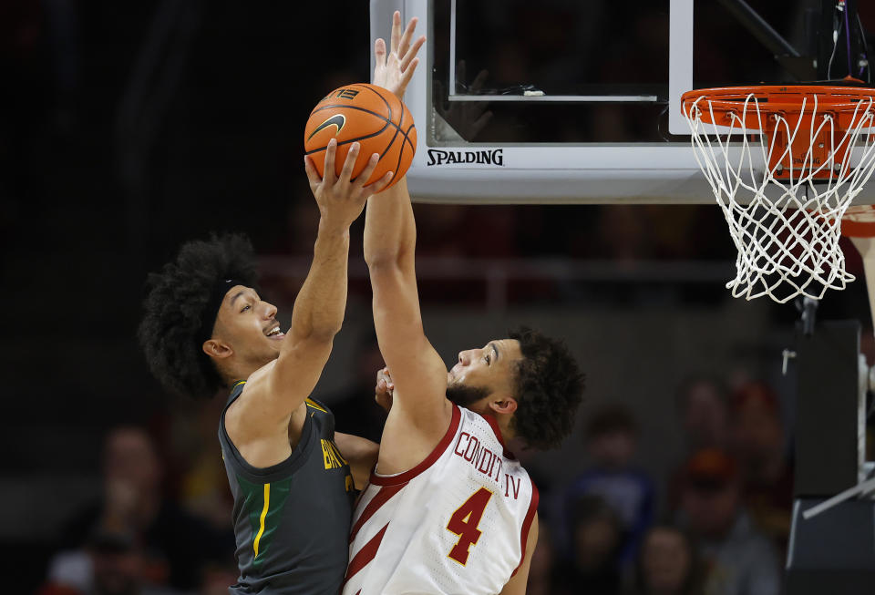 Baylor guard Kendall Brown (2) looks for a shot past Iowa State forward George Conditt (4) during the first half of an NCAA college basketball game, Saturday, Jan. 1, 2022, in Ames. (AP Photo/Matthew Putney)