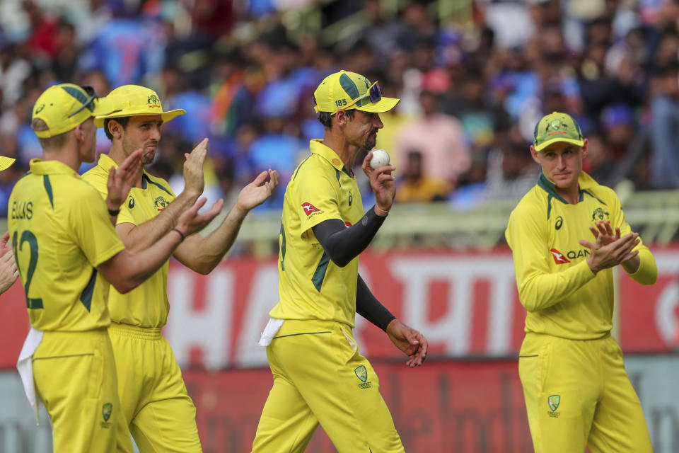 Australia's Mitchell Starc, second right, holds the ball after taking five wickets as he walks off with his teammates at the end of their fielding innings during the second one-day international cricket match between India and Australia, in Visakhapatnam, India, Sunday, March 19, 2023. (AP Photo/Surjeet Yadav)