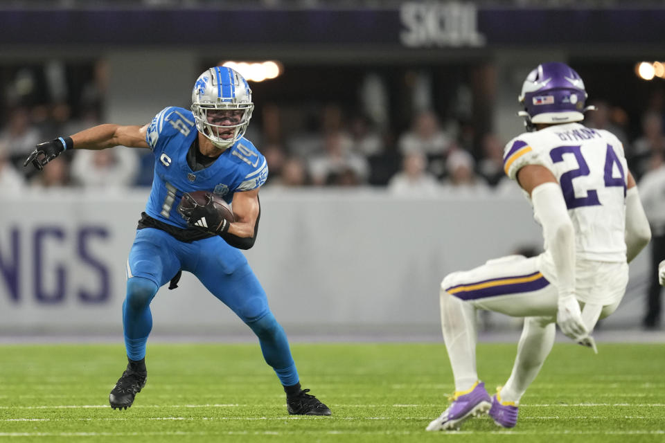 Detroit Lions wide receiver Amon-Ra St. Brown (14) runs from Minnesota Vikings safety Camryn Bynum (24) after catching a pass during the second half of an NFL football game, Sunday, Dec. 24, 2023, in Minneapolis. The Lions won 30-24. (AP Photo/Abbie Parr)