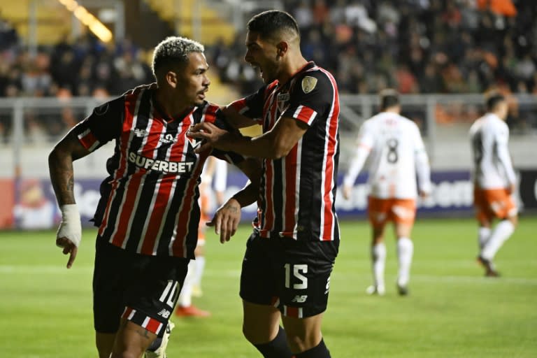 Picture released by Photosport showing Sao Paulo's forward Luciano (L) celebrating with teammate Sao Paulo's Uruguayan midfielder Michel Araujo after scoring during the Copa Libertadores group stage second leg football match between Chile's Cobresal and Brazil's Sao Paulo at Zorros del Desierto Stadium in Calama, Chile, on May 8, 2024. (Pedro TAPIA)