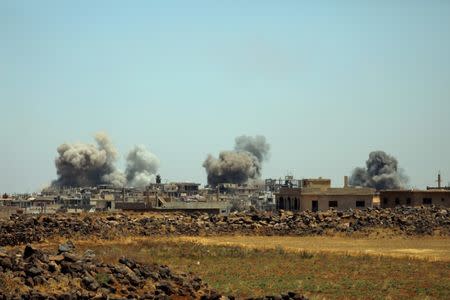 Smoke rises from al-Harak town, as seen from Deraa countryside, Syria June 25, 2018. REUTERS/Alaa al-Faqir