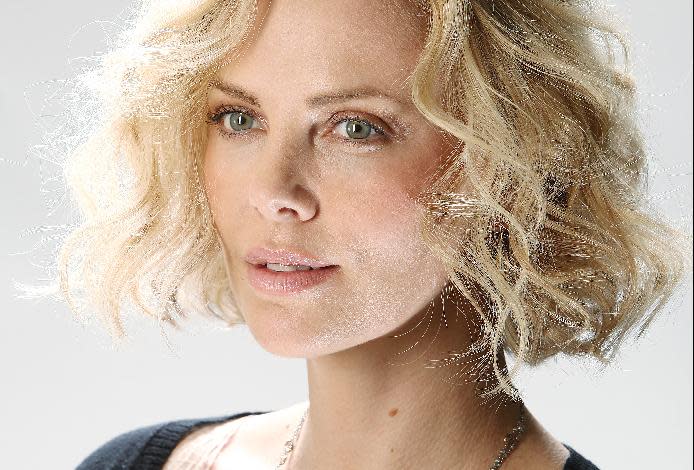 FILE - In this Dec. 9, 2011 file photo, actress Charlize Theron poses for a portrait in New York. Theron's publicist told The Associated Press, Wednesday, March 14, 2012, that the actress is the mother of an adopted healthy baby boy named Jackson. No other details were provided. (AP Photo/Carlo Allegri, file)