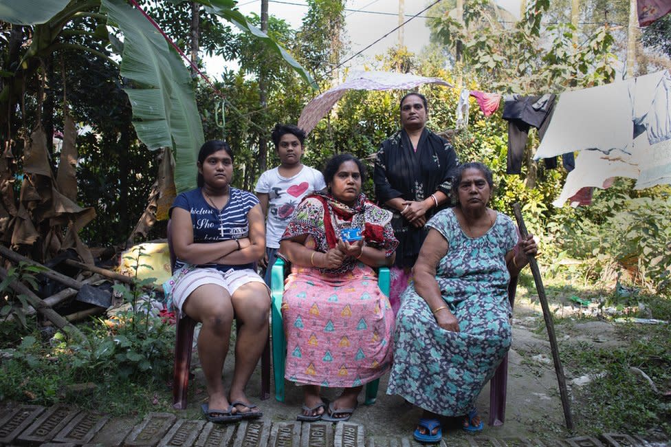 Mallika Kar (seated, middle) with her family in Bishnupur, West Bengal. Kar is a widow. On her left is her daughter Manisha Kar and on her right is her mother Premlata Dhara. Standing behind is her sister in law Barnali Dhara and her son, Noel Dhara - West Bengal welfare case study