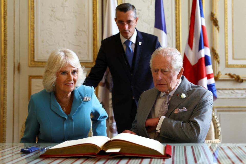 The royal couple signing the visitor book at the Hotel de Ville (Hannah McKay/PA)