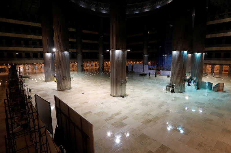 Security officers walk inside The Great Mosque of Istiqlal as it is closed during the spread of coronavirus disease (COVID-19) in Jakarta
