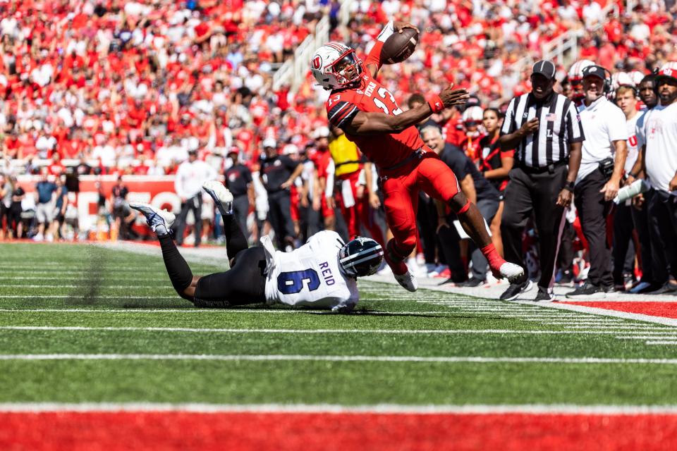 Utah Utes quarterback Nate Johnson (13) runs past Weber State Wildcats linebacker Winston Reid (6) during their football game at Rice-Eccles Stadium in Salt Lake City on Saturday, Sept. 16, 2023. | Megan Nielsen, Deseret News