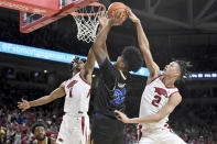 Arkansas defenders Ricky Council IV (1) and Trevon Brazile (2) go up to block the shot of San Jose State forward Robert Vaihola (22) during the first half of an NCAA college basketball game Saturday, Dec. 3, 2022, in Fayetteville, Ark. (AP Photo/Michael Woods)