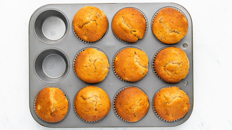 peach muffins in muffin tin