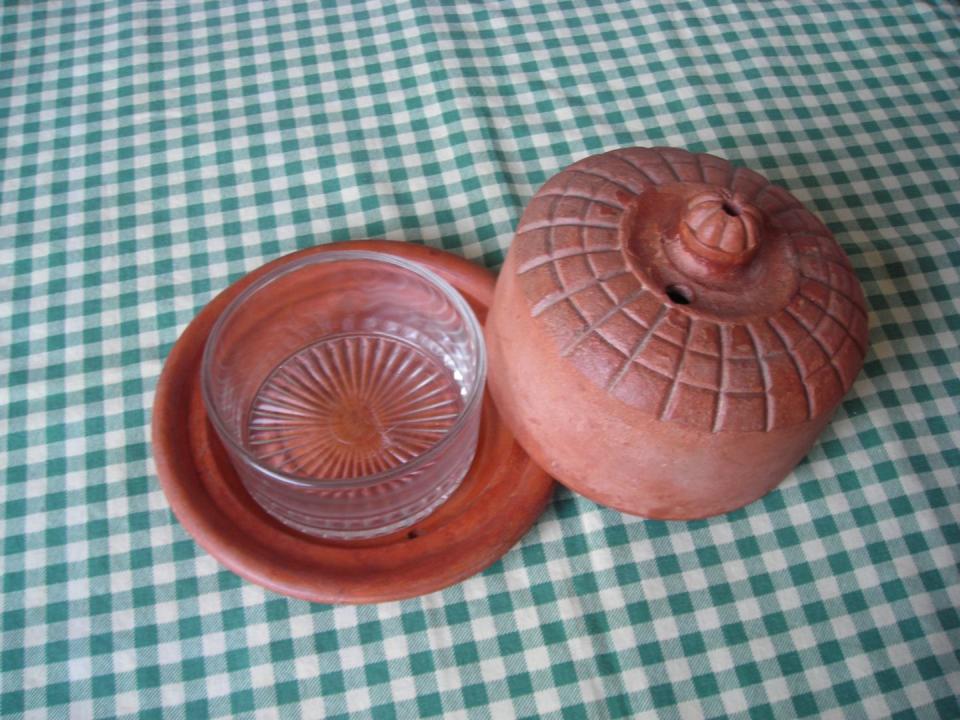 <p>The <a href="https://www.etsy.com/listing/471320710/vintage-french-butter-dish-terracotta" rel="nofollow noopener" target="_blank" data-ylk="slk:clever design;elm:context_link;itc:0;sec:content-canvas" class="link ">clever design</a> allowed for cool water to fill the area on the saucer around the glass bowl—effectively keeping butter chilled but still soft enough to spread.</p>