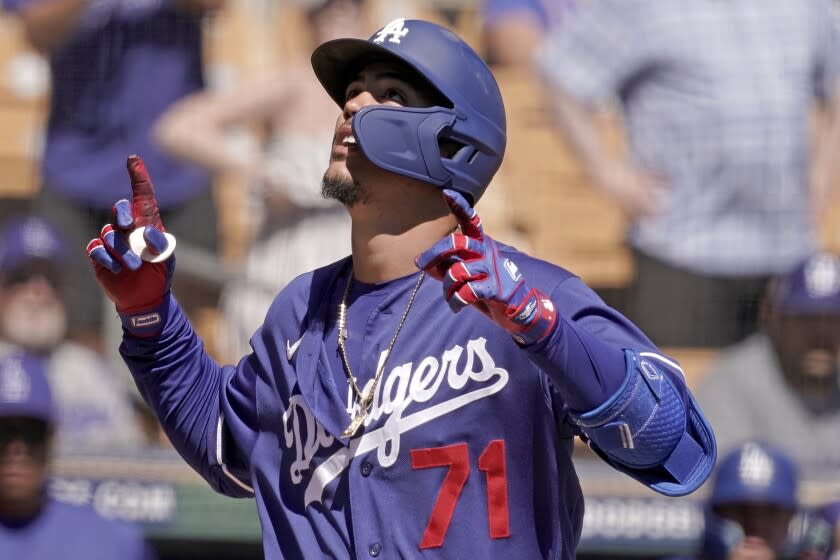 Los Angeles Dodgers' Miguel Vargas celebrates as he crosses the plate after hitting a three-run home run during the second inning of a spring training baseball game against the Cleveland Guardians Wednesday, March 23, 2022, in Glendale, Ariz. (AP Photo/Charlie Riedel)