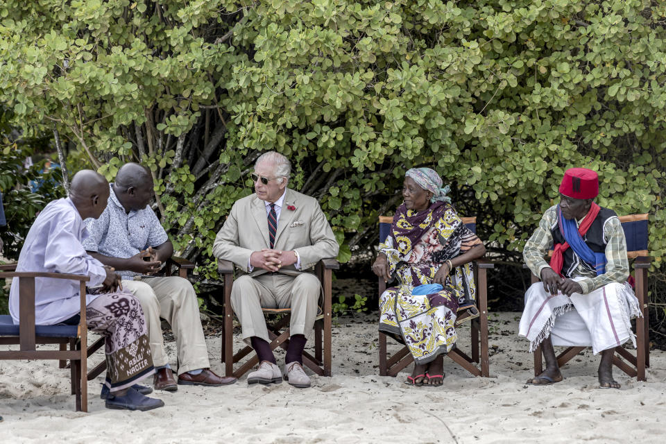 Britain's King Charles III, center, meets with community elders on the beach during a visit to Kuruwitu Conservation Area in Kilifi, Kenya, Thursday, Nov. 2, 2023. (Luis Tato/Pool Photo via AP)