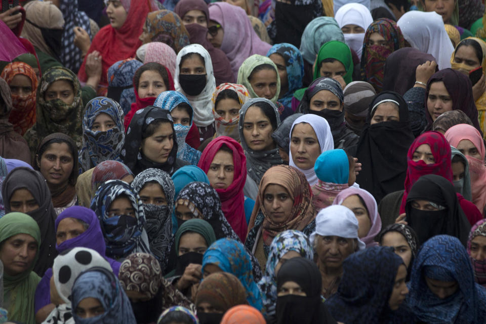 Kashmiri villagers watch the funeral procession of Zakir Musa, a top militant commander linked to al-Qaida, as it rains in Tral, south of Srinagar, Indian controlled Kashmir, Friday, May 24, 2019. Musa was killed Thursday evening in a gunfight after police and soldiers launched a counterinsurgency operation in the southern Tral area, said Col. Rajesh Kalia, an Indian army spokesman. (AP Photo/Dar Yasin)