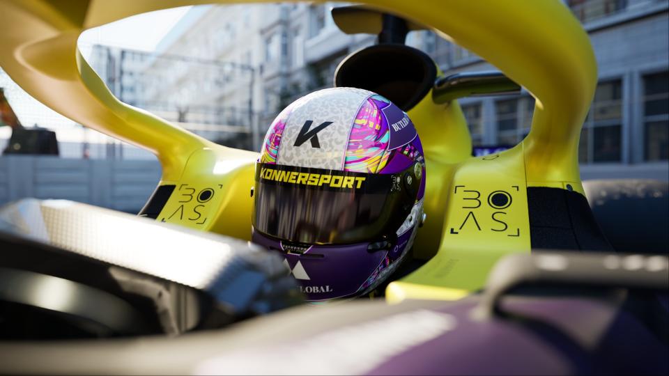 A close up of a racer in a purple and yellow car