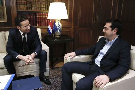 Jeroen Dijsselbloem (L), head of the euro zone finance ministers' group, sits with Greece's Prime Minister Alexis Tsipras as he is welcomed to his office in Athens, January 30, 2015. REUTERS/Petros Giannakouris/Pool