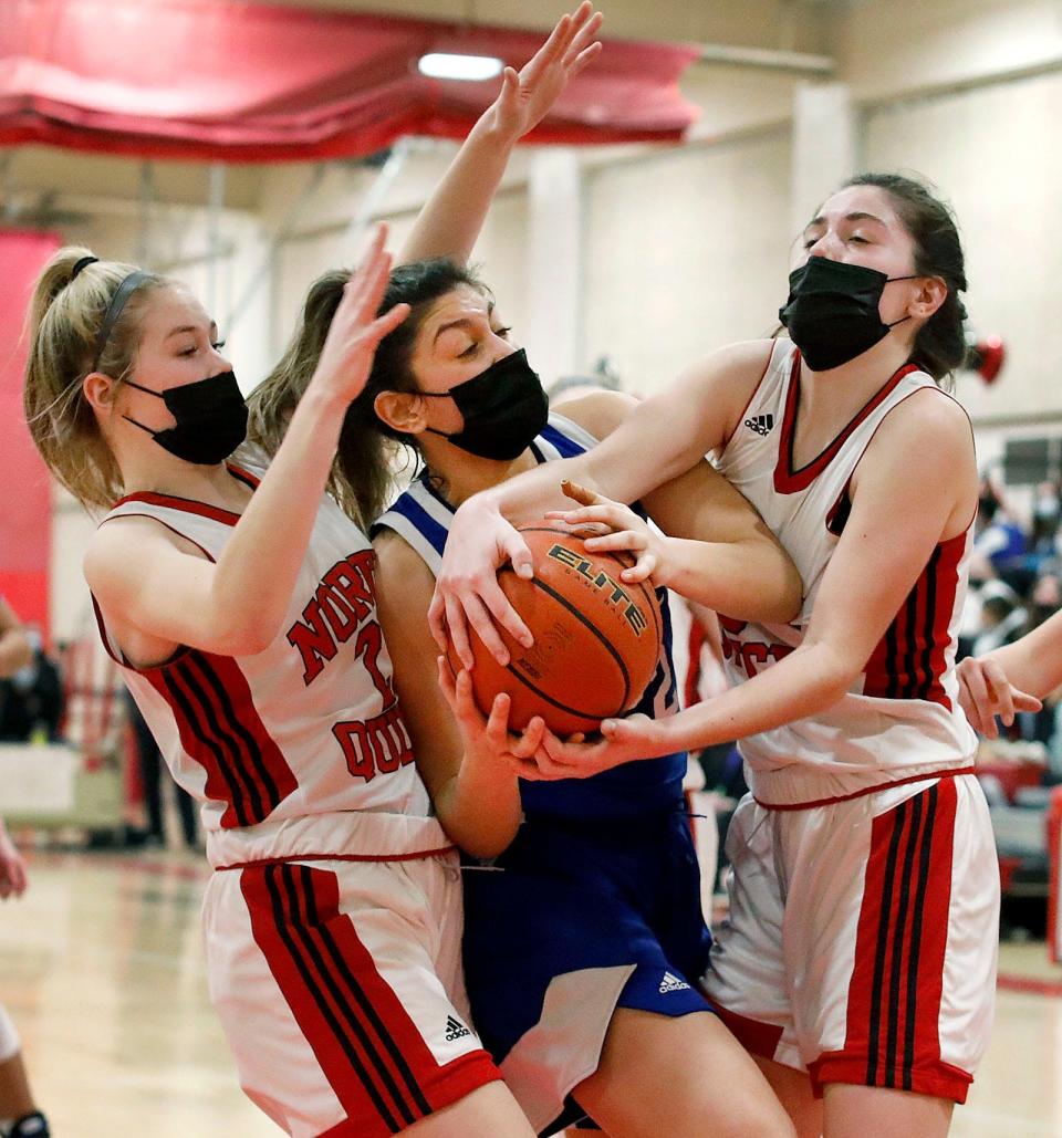 Quincy's Antenella Ibrahim, center, forces a jump ball. North Quincy hosted Quincy in girls basketball on Friday, Jan. 21, 2022.