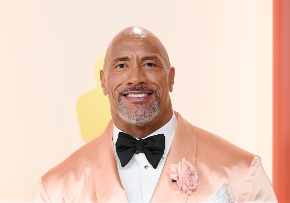 Dwayne Johnson at a film premiere in a pink tuxedo