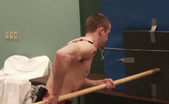 A volunteer performs a spear-thrusting task like a Neanderthal would as electrodes monitor his muscle activity.