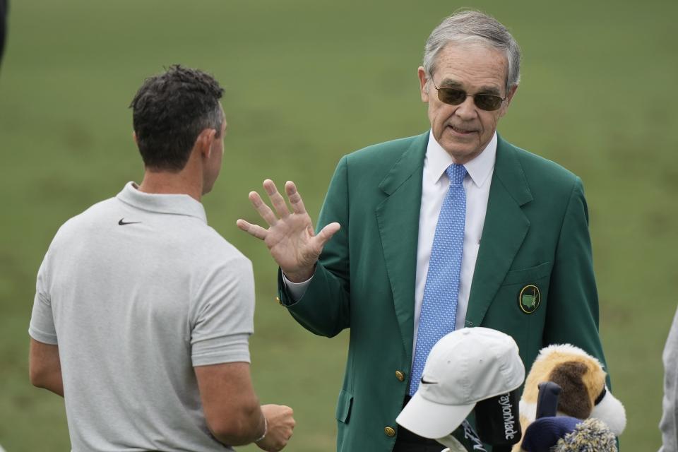 Rory McIlroy, of Northern Ireland, talks with Billy Payne, the former chairman of Augusta National Golf Club and the Masters Tournament on the driving range during a practice round in preparation for the Masters golf tournament at Augusta National Golf Club Tuesday, April 9, 2024, in Augusta, Ga. (AP Photo/Charlie Riedel)