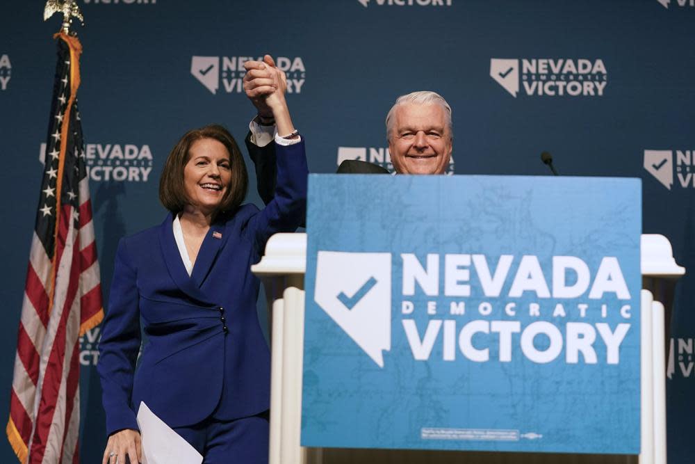 Sen. Catherine Cortez Masto, D-Nev., left, reacts alongside Nevada Gov. Steve Sisolak during an election night party hosted by the Nevada Democratic Party, Tuesday, Nov. 8, 2022, in Las Vegas. (AP Photo/Gregory Bull)